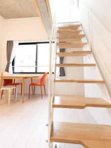 a staircase in a house with a table and chairs at ラフィット両国 in Tokyo