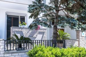 una casa con una recinzione e un albero di Vele d'Otranto B&B a Otranto