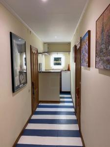 a hallway with a blue and white floor and a kitchen at ArtOtrada Mini-hotel in Odesa