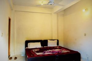 a small room with a bed in a room at Bypass Hotel in Swat