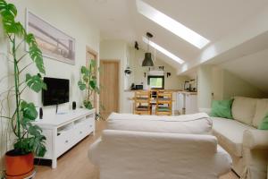 a living room with a couch and a kitchen at VUKAJLO apartment Belgrade in Belgrade
