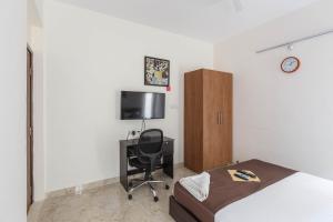 a bedroom with a bed and a desk and a chair at BluO 1BHK Koramangala - Terrace Garden, Parking in Bangalore