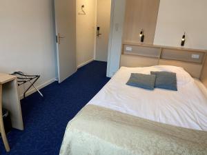 Voodi või voodid majutusasutuse Herning City Hotel toas