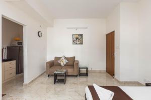 a living room with a couch and a table at BluO Studio Koramangala - Terrace Garden, Parking in Bengaluru +3 photos