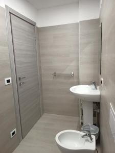 a bathroom with a sink and a toilet and a shower at Residence Carlo in Grado