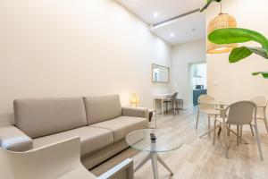 a living room with a couch and a table at Kayser Premium Suites in Seville