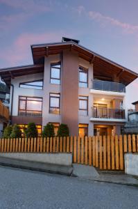 a house with a fence in front of it at Къща за гости" Никола" in Devin