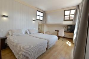 Postel nebo postele na pokoji v ubytování Hostal Concejo