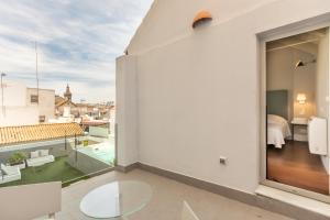 a balcony with a view of a bedroom at Kayser Premium Suites in Seville +52 photos