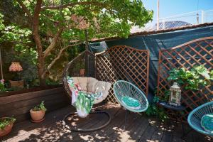 a swing sitting next to two chairs on a patio at Apartment Borna in Cavtat