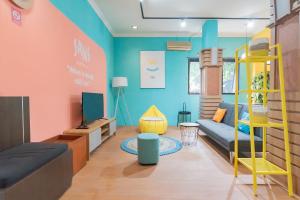 a living room with a couch and a bunk bed at Sans Hotel Cihampelas Bandung in Bandung