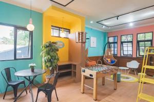 a play room with a table and chairs at Sans Hotel Cihampelas Bandung in Bandung