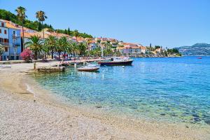 una playa con barcos en el agua junto a los edificios en Guest House Jungher en Korčula