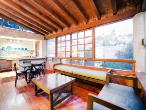 a room with a bench and tables and windows at Hotel Casona de Minas in Mineral del Monte +45 photos