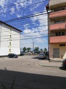 a parking lot with cars parked next to a building at L.M. in Sulina