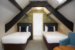 A bed or beds in a room at Old Manse Hotel by Greene King Inns