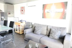 a living room with a couch and a table at Sanne in Roses