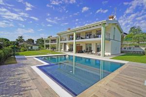 a large house with a swimming pool in front of it at Gardaliva 5 in Manerba del Garda