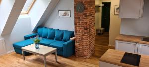 a living room with a blue couch and a table at Home away home in Tartu