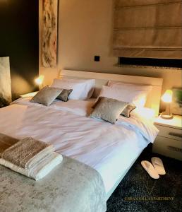 a large white bed with two pillows on it at URBAN VILLA APARTMENT in Opatija