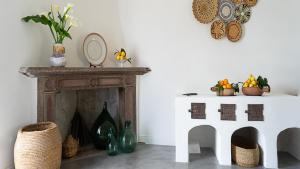 a room with a fireplace and a table with a mirror at Albergo Rurale Casa Fois in Valledoria +67 photos