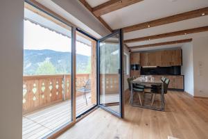 a kitchen and dining room with sliding glass doors at Franz Johann Appartements - near slopes - Reiteralm in Schladming