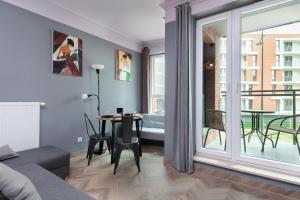 a living room with a couch and a table at Gdansk Old Town Walowa Apartments by Renters in Gdańsk