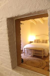 a bedroom with a bed and a mirror on the wall at Can Barrina in Montseny