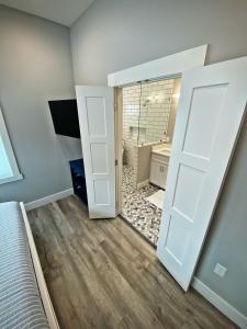 a bedroom with a door leading to a bathroom at Gulf-View, New-Build w/ Pool, & EV Charging in Port Aransas