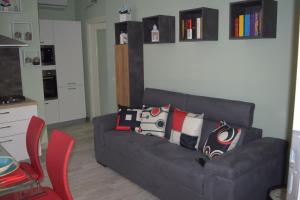 a living room with a couch with pillows on it at Il Portico in Peschiera del Garda