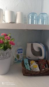 a shelf with a coffee maker and a basket of food at Greek House Hotel in Neos Marmaras