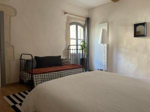 Кровать или кровати в номере Le Patio d'Arles