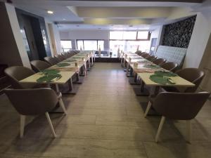a row of tables in a room with chairs at Temizay Hotel in Çanakkale