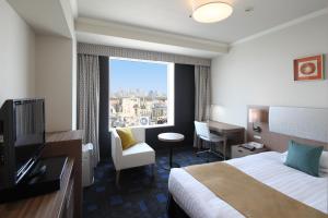 a hotel room with a bed and a large window at Shibuya Excel Hotel Tokyu in Tokyo