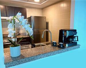 a kitchen with a stainless steel refrigerator and a coffee maker at Beautiful Close to Beach Dubai Marina Apartment in Dubai