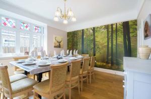 a dining room with a large table and chairs at Grove Lodge in Gosport