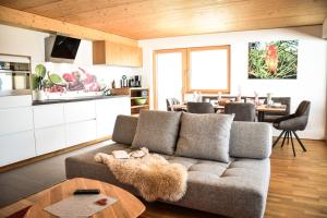 a living room with a couch and a table at Haus Alpenblick in Schröcken