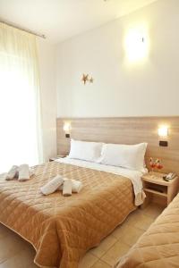 Säng eller sängar i ett rum på Hotel Costazzurra by Interlux