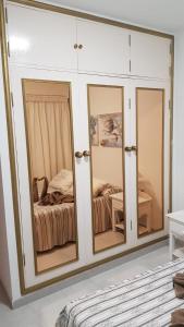 a room with a white cabinet with mirrors at Casa Érika in Puerto del Rosario