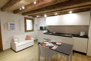 a kitchen and living room with a table and a couch at Tre Raggi Apartment in Venice