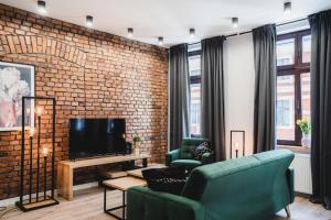 a living room with a brick wall at Modern Apartments Toruń 3 in Toruń