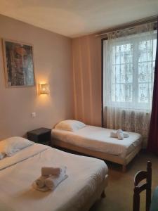 Postel nebo postele na pokoji v ubytování Hotel Kelig