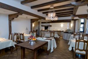 a dining room with tables and chairs and a chandelier at Hotel Domschenke in Billerbeck