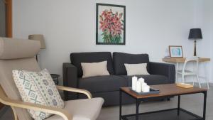 a living room with a couch and a table at Apartamentos Calma Rentals in Torremolinos