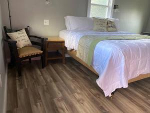 a bedroom with a bed and a table and a chair at Murphys Law Inn 2 in Leeds