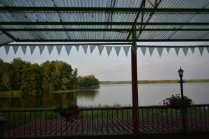 a view of a lake from a screened in porch at Oleandria -,,Domek Jeżynka" nr 30 in Biskupiec
