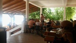 a group of people sitting at a restaurant at Apartmentsin Pasman with Air condition, WIFI 4650-1 -2 in Pašman