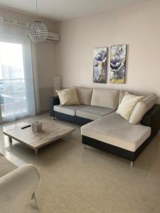 a living room with a couch and a coffee table at Anna Apartments in Keramoti