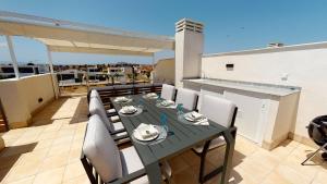 a table and chairs on the roof of a balcony at Villa Mercurio - A Murcia Holiday Rentals Property in Los Alcázares