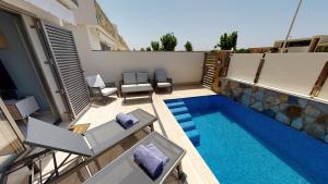 an overhead view of a swimming pool with chairs at Villa Mercurio - A Murcia Holiday Rentals Property in Los Alcázares